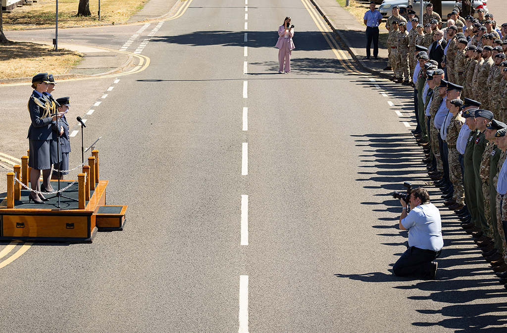Seen here, an overhead and close up view of both Group Captains standing on a dais at the handover ceremony, attended by personnel from across the Station, and invited guests, who are recognising both the achievements of the outgoing Station Commander and the appointment of her successor.
